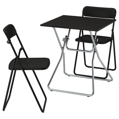 A black GUNDE foldable table and chair set made of steel and plastic, designed for easy storage.