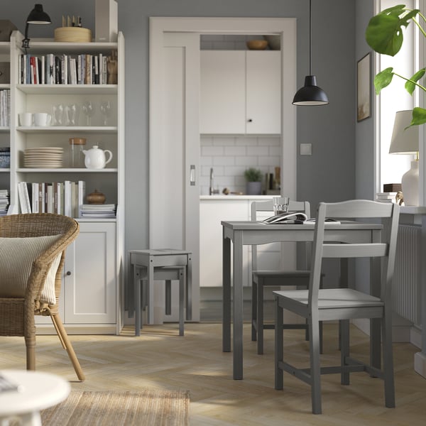 Grey HAUGA 2-seat dining set with storage & kitchen peek.