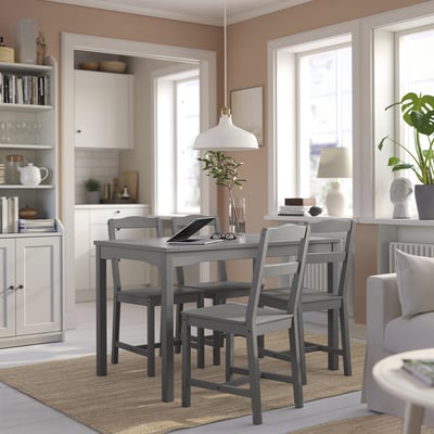 Cosy dining area with modern rectangular grey HAUGA table and chairs. Bright, stylish room with white walls, large windows, and natural light.
