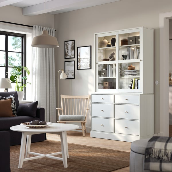 Modern living room with HAVSTA cabinet, dark sofa, and rustic decor.