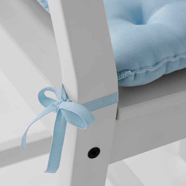 Light blue chair pad with decorative bow tie, attached to white chair frame, ensuring comfort and coolness.