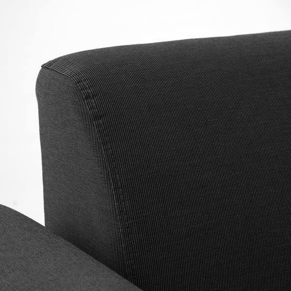 Dark grey sofa corner with clean lines and visible stitching, showcasing durable fabric and modern design.