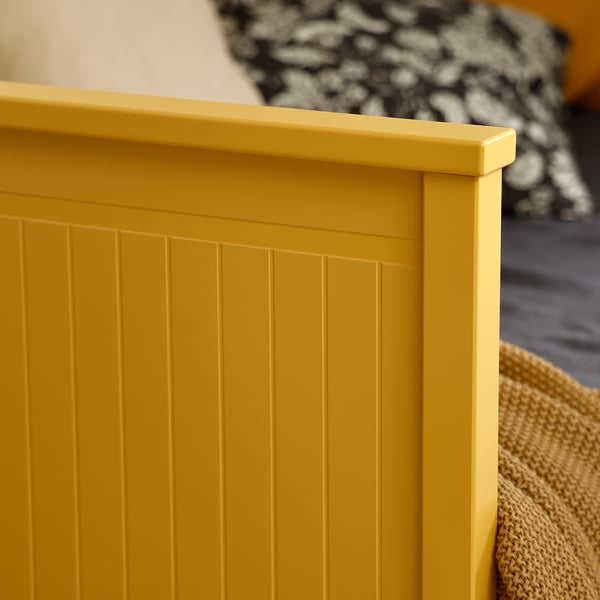 Bright yellow wooden furniture close-up, showing smooth finish and neat panel design.