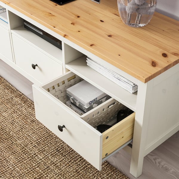 Wooden tv stand with drawer open, showing organised games and electronic storage.