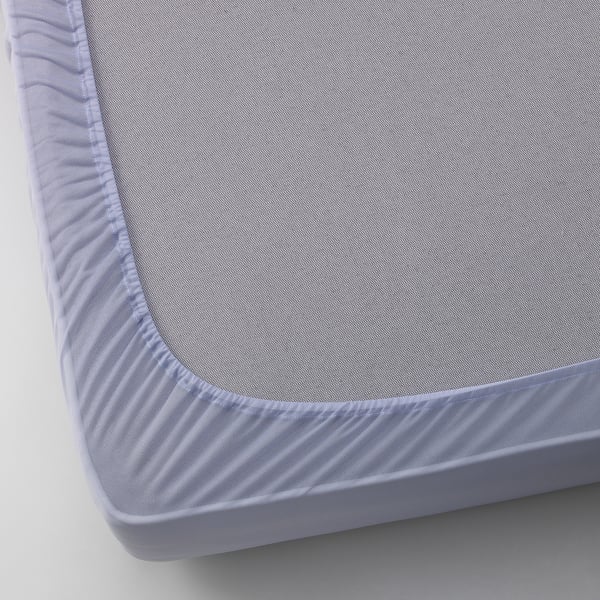 Close-up of a neatly fitted grey mattress protector with elastic edges, showing quality fabric and stitching details.