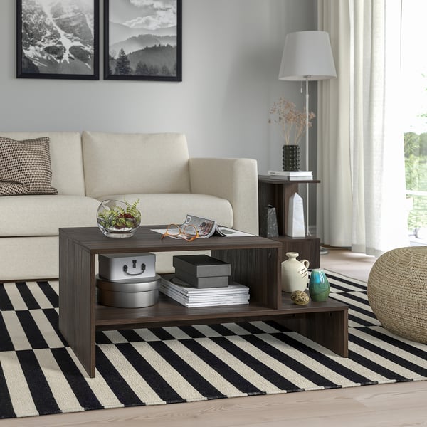 HOLMERUD coffee table with open storage on striped rug, holding books, plant, and decor.