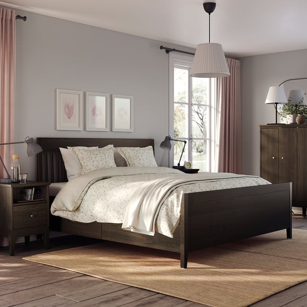 Calm bedroom with grey IDANÄS bed, white linens, wooden nightstands, large window, hanging lamp, and art prints.