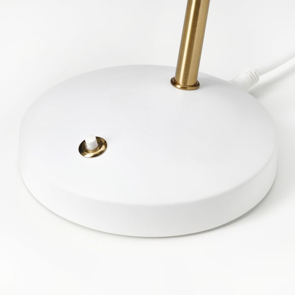 Modern white lamp with gold accents and flexible neck, plugged in.