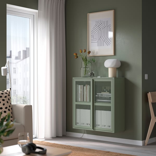 Modern living room with green IVAR mesh cabinet, picture, lamp, and tulips.