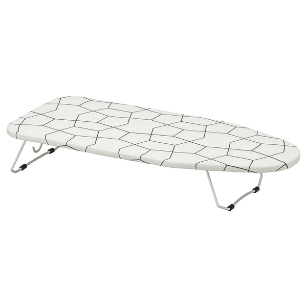 A JÄLL ironing board. Its white with a hexagon-patterned mesh surface. The board has foldable legs and hooks for wall mounting.