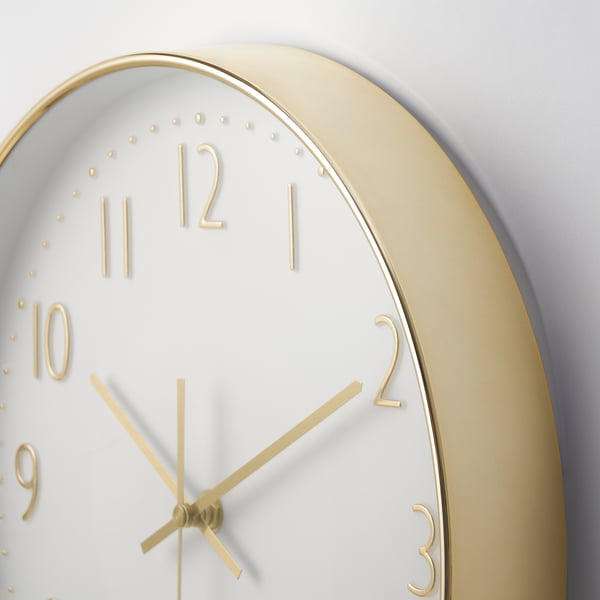 Gold-framed silent clock with white face and gold details.
