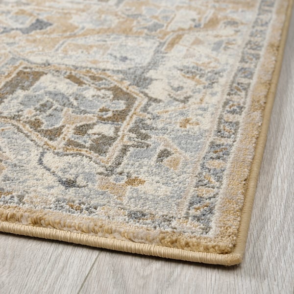 A plush, multi-colored area rug with intricate patterns and a thick pile, designed for durability and easy maintenance.
