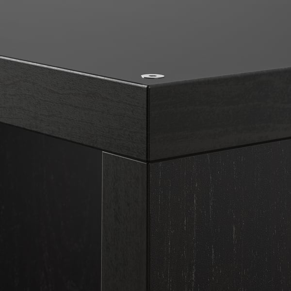 Black KALLAX shelf unit corner, smooth finish, sturdy build.