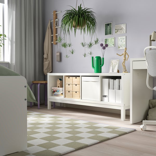 KALLAX white shelf with books & decor next to bed, under plant.
