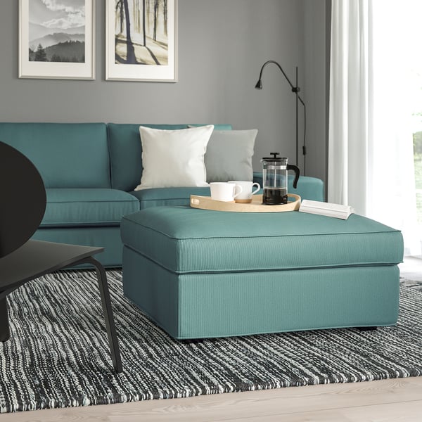 Teal KIVIK footstool & sofa, living room setup with storage.