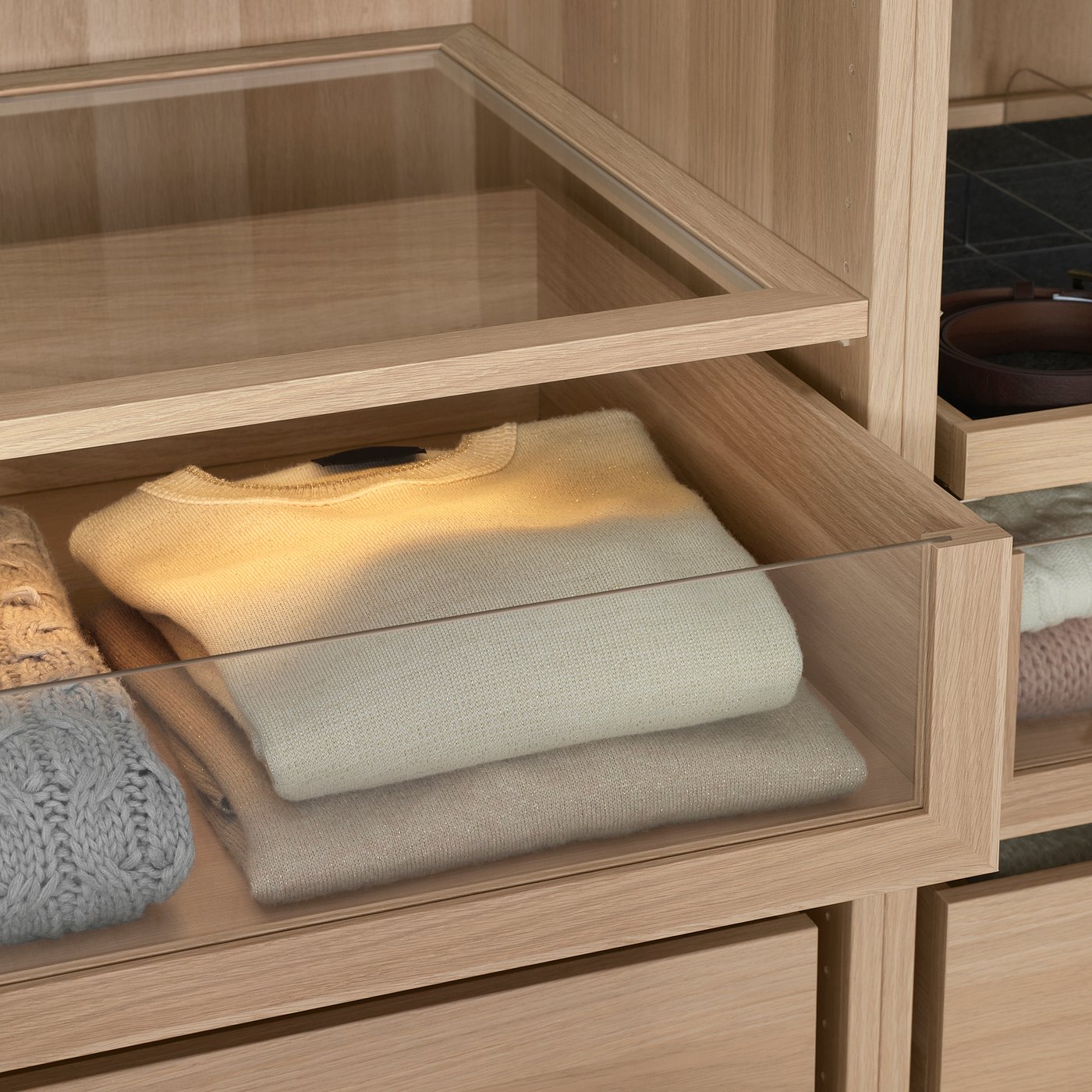 Neatly organised drawer with sweater and socks.