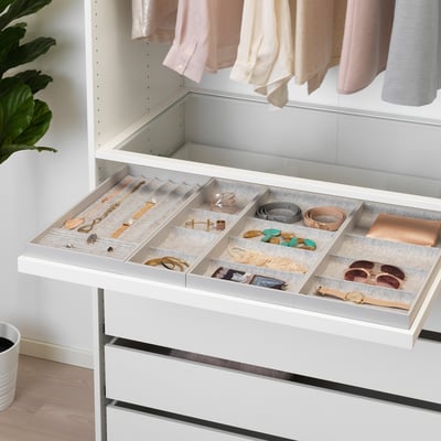 White drawer organiser with felt compartments for jewellery and accessories inside a wardrobe.