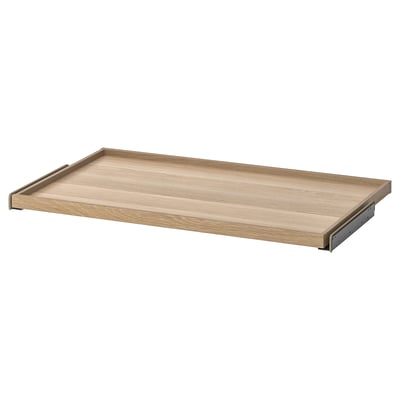 An ikea KOMPLEMENT pull-out tray in light oak color, designed for wardrobe storage, with a wooden and metal design.