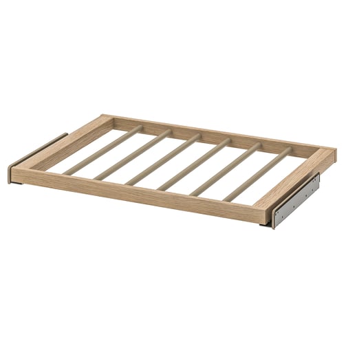 A KOMPLEMENT wooden trouser hanger in natural colour, featuring a rectangular frame with metal brackets.
