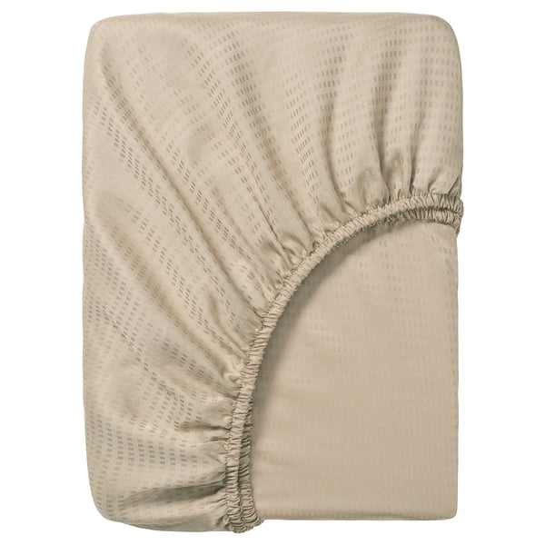 Fitted sheet named LÄKEVÄNDEROT, beige, made of 100% lyocell, rectangular with elastic corners, subtle dobby pattern.