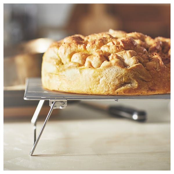 Golden-brown pastry on a cooling rack, freshly baked with a bubbly texture.