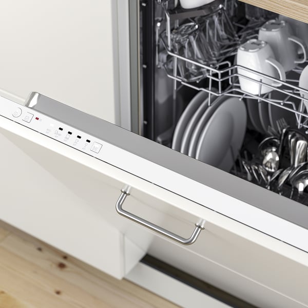 Open dishwasher showing stacked plates and cutlery, control panel on front.