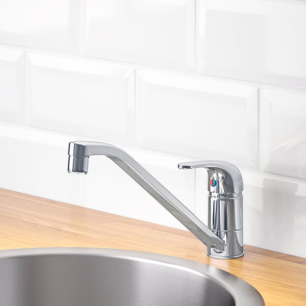 Modern chrome tap on wooden counter, 360° swivel for efficient water flow.