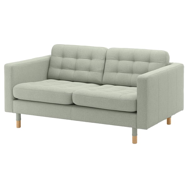 A light grey, modern sofa named LANDSKRONA with wooden legs, a tufted back, and plush cushions.