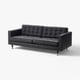 Black leather couch, tufted back & seat, metal legs, minimalist design.