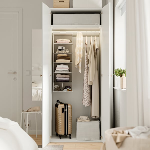 Open wardrobe with folded clothes, hanging coats, and storage boxes. Adjustable feet for floor irregularities.
