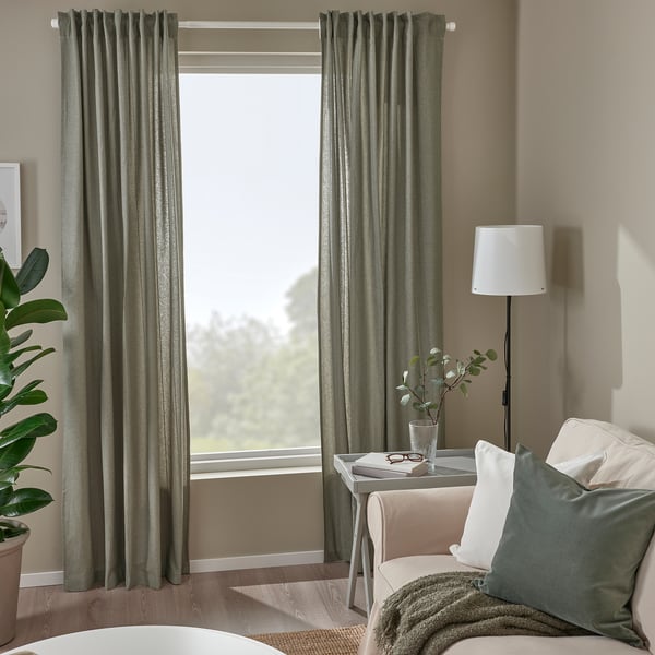 LENDA curtains in light grey-green by window, 100% cotton with tiebacks, complementing cosy seating area.