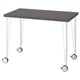 A modern desk named LINNMON with a black top and white hairpin legs featuring wheels for easy movement.