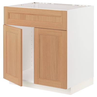 A METOD kitchen cabinet in light oak. It two doors and a drawer, with a sleek, wooden finish and sturdy frame construction.