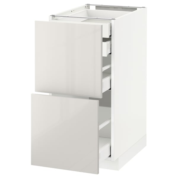 White METOD kitchen cabinet with high-gloss finish and multiple drawers.
