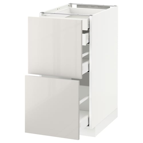 White METOD kitchen cabinet with high-gloss finish and multiple drawers.