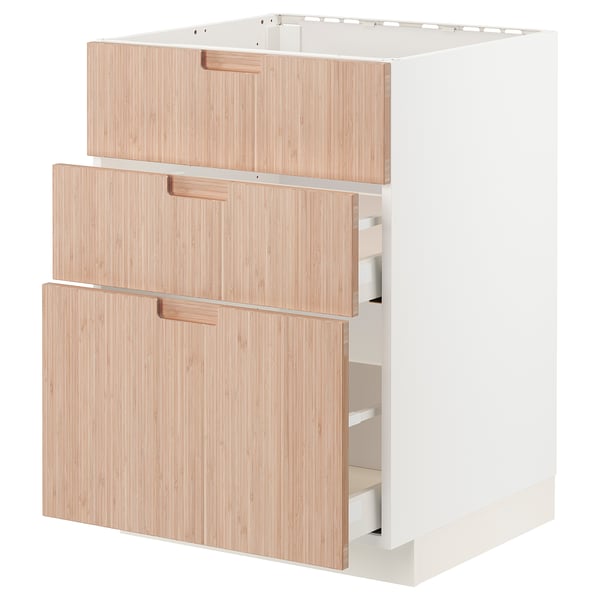 A white ikea METOD kitchen cabinet with three light bamboo drawers.