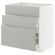 A white METOD kitchen unit with grey havstorp drawers in a modern design.