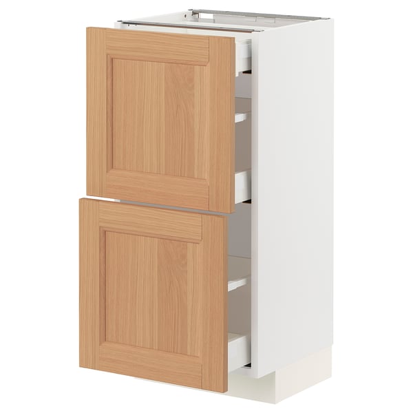 A METOD kitchen cabinet with oak drawer fronts, featuring two drawers and a door. The cabinet is white and has a modern design with a sturdy frame.