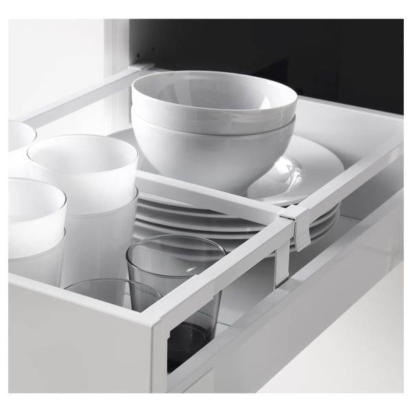 Kitchen drawer with white dishware: cups, bowls, and plates, organised in white METOD system.