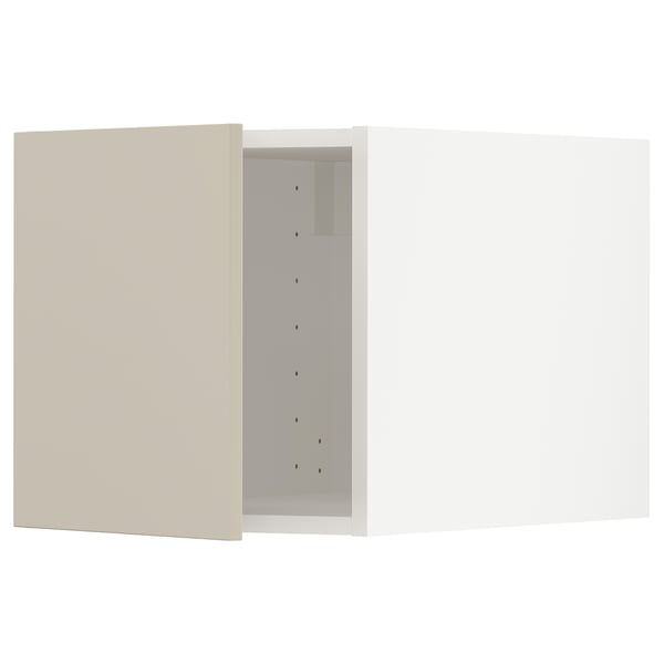 METOD kitchen in beige with sleek, modern design, featuring smooth surfaces and vertical line of drilled holes.