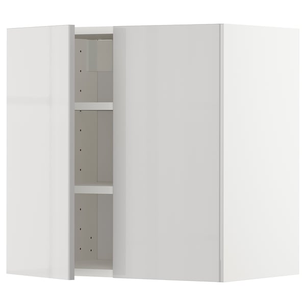A white METOD kitchen wall cabinet with grey shelves. It has a glossy finish and adjustable shelves.
