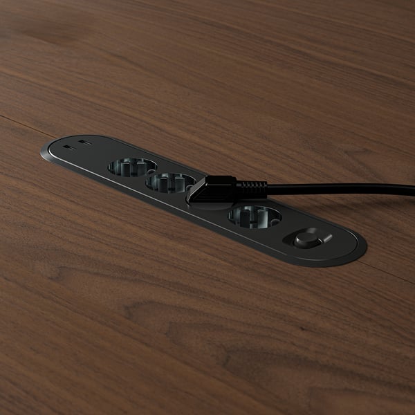 Round conference table with built-in power outlet and usb ports for device charging.