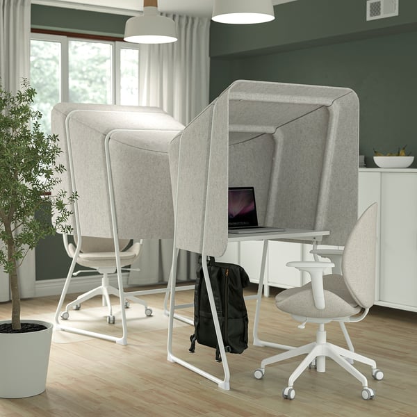 Mitzon privacy booth in minimalist office with laptop, plant, chairs