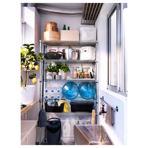 Wire shelving unit with assorted items, featuring blue water cooler bottles and various kitchenware.