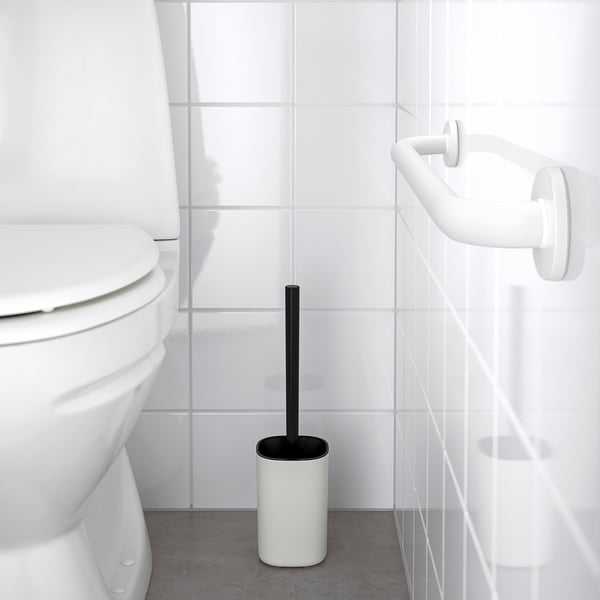 Minimalist white grab bar near toilet. OMTÄNKSAM series for support. Matte finish, sturdy steel, wall-mounted. Smaller than toilet.