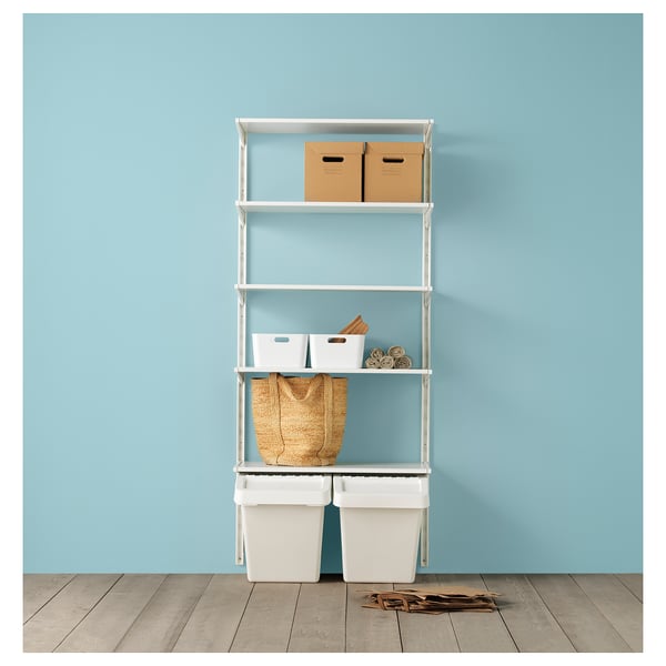 Shelves with drawers, boxes, basket, and bins against blue wall.