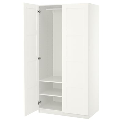 White PAX wardrobe, open, featuring adjustable feet and interior shelves for organisation.