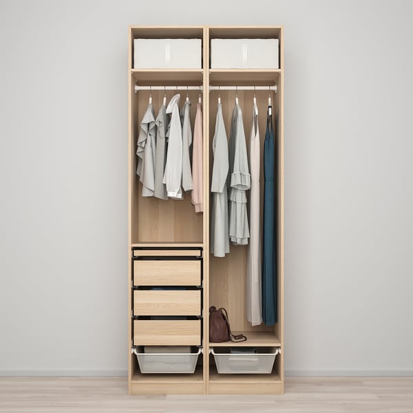 A wooden wardrobe with hanging clothes, drawers, and baskets, designed for versatile storage.