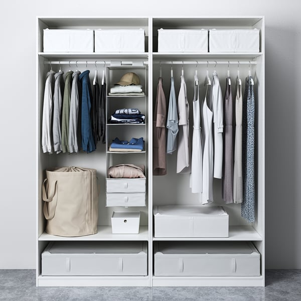 Open wardrobe with shirts, bags, bins. Shelves and drawers for clothes and accessories.