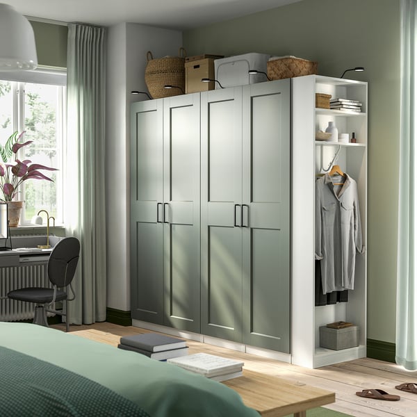 Modern bedroom with light green PAX wardrobe, open closet, and desk.